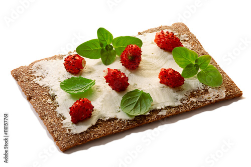 Bread crisp with fresh strawberries, soft cheese and mint photo