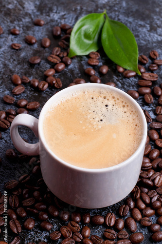 cup of fresh americano on coffee beans background © katrinkivi