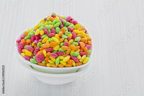 Colorful Rice Cereal on the pink dishcloth with glass of water a