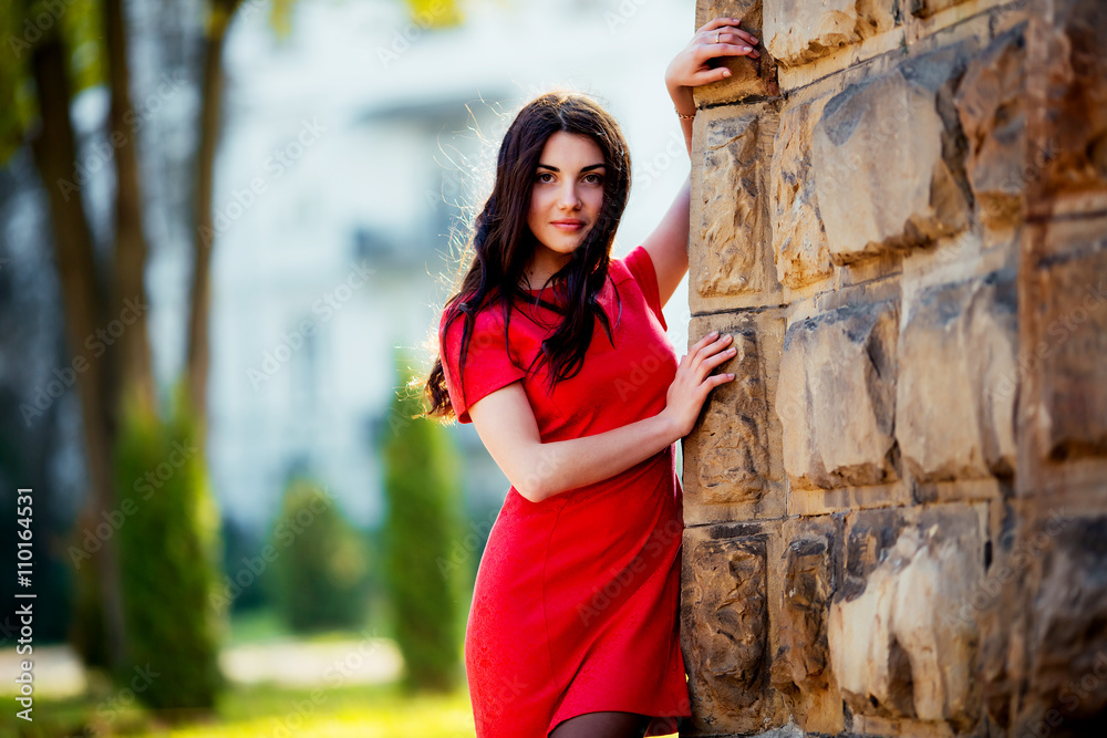Fototapeta premium portrait of a beautiful girl on the street. photo with warm colors