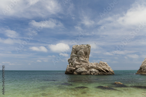 One of the Two Sister (Due Sorelle) reef, in the Conero Mountain , adriatic sea, Italy. Blue sky background with clouds