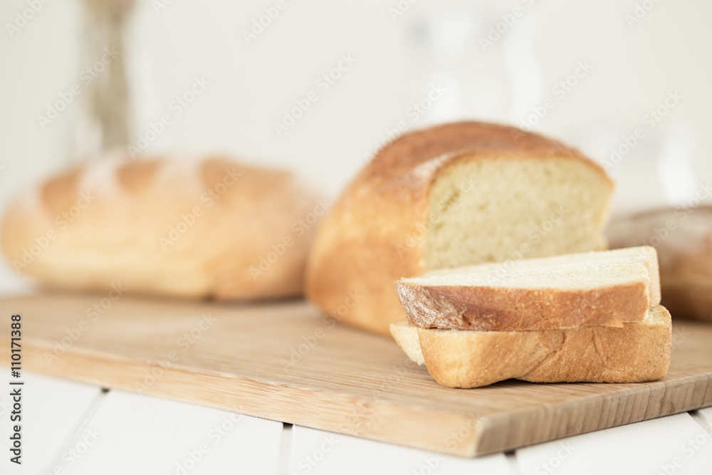 Slices and bun of  fresh white bread