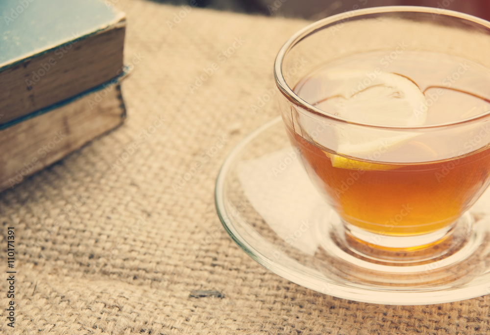 Hot lemon tea on table with soft light morning.
Hot lemon tea on table with soft light morning.