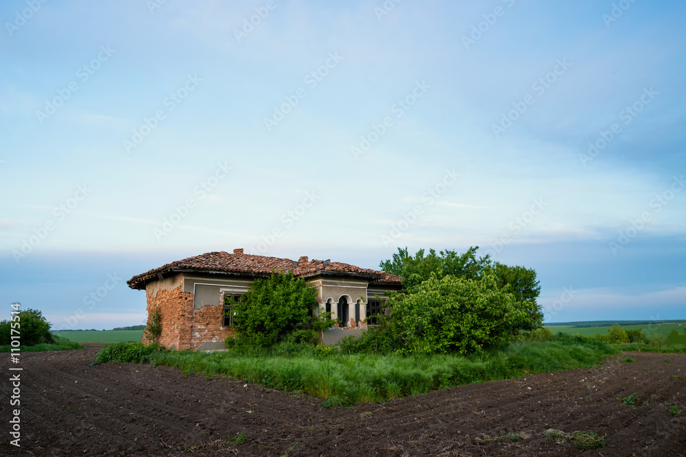abandoned old rustic house in the middle of the field