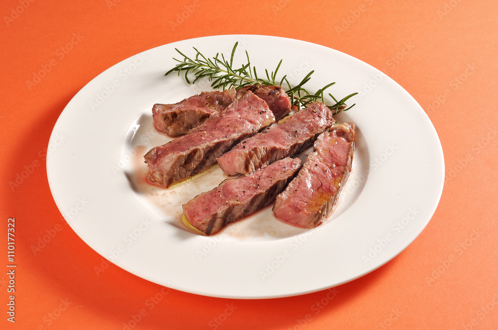 Plate with grilled steak portion