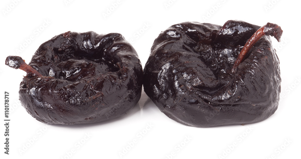 two dried prunes isolated on a white background closeup macro two dried prunes isolated on a white background closeup macro