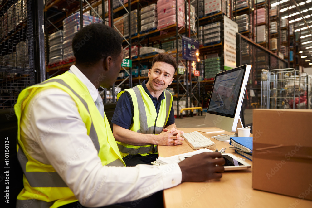 Ταπετσαρία Staff discuss warehouse logistics in an on-site office