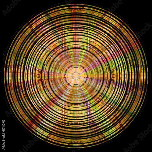 Abstract circular gold, red, green and pink disc with spectral rays on a black background