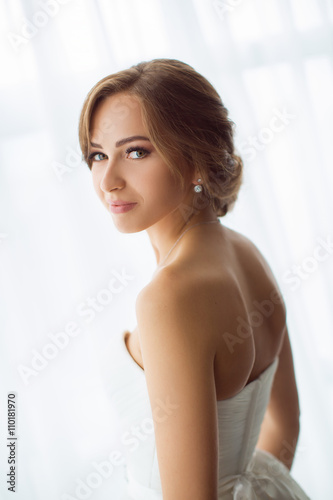 Brides beauty. Young woman in wedding dress indoors © Buyanskyy Production