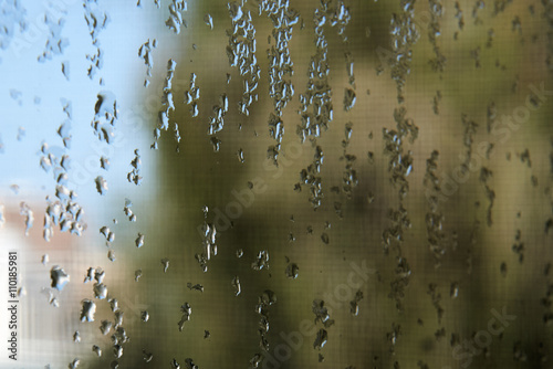 Fotografie, Obraz Water drops on a window pane with blurry background