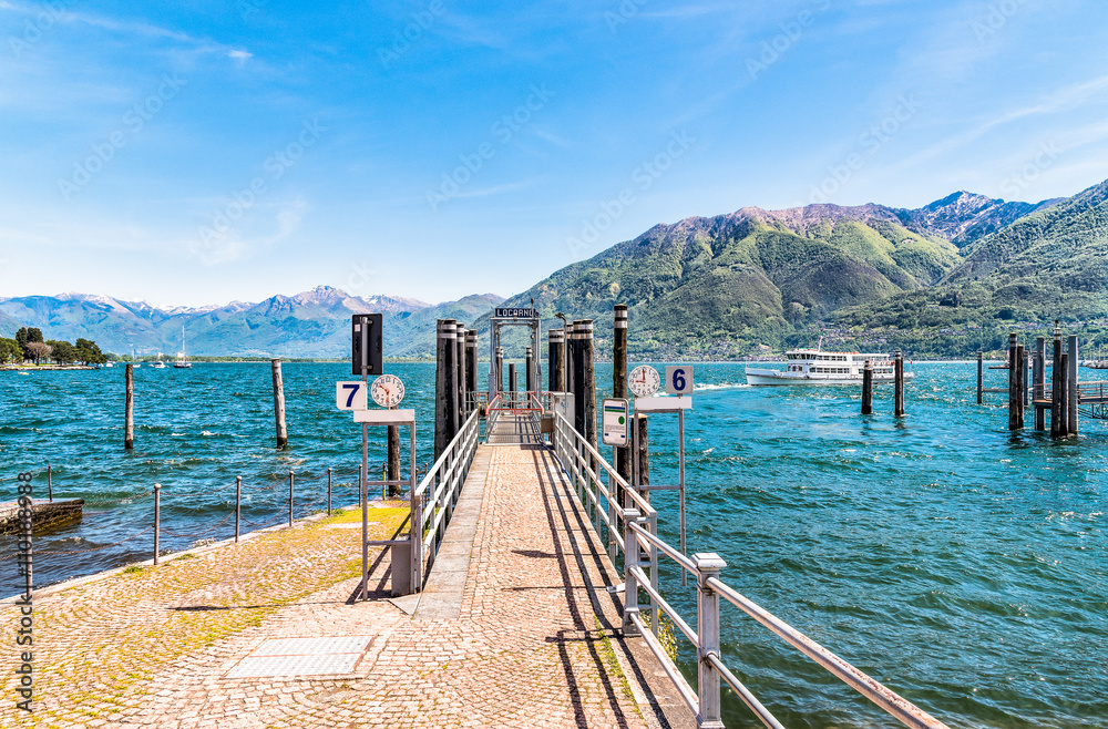Obraz premium Ferry boat at the pier on the shore of lake Maggiore in Locarno, Switzerland