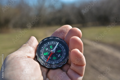 Compass in the hand on a walk.