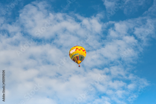 Hot air balloon over blue sky © siwarit01