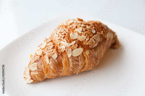 Fresh croissant on white plate