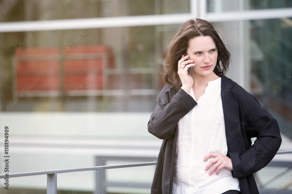 young woman standing outside and talking on phone young woman standing outside and talking on phone