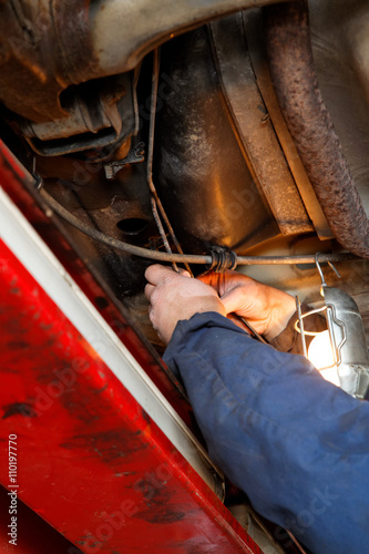 hands of an auto mechanic repairing the brake