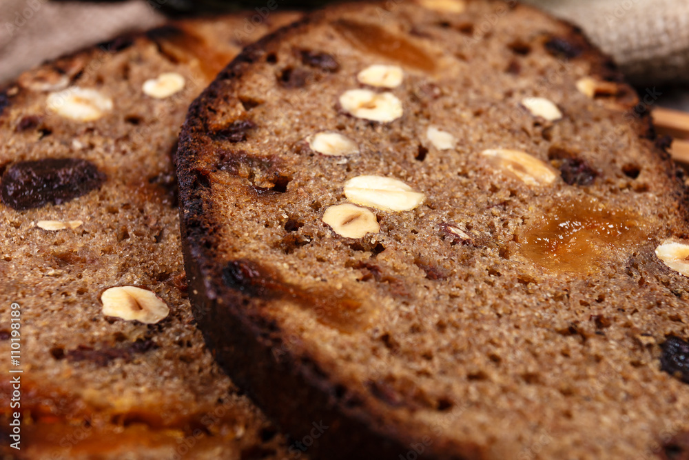Sliced rye bread with prunes, dried apricots and hazelnut on old rustic table Sliced rye bread with prunes, dried apricots and hazelnut on old rustic table