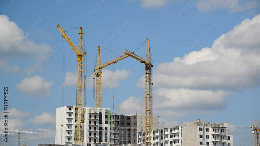 Construction cranes against  sky