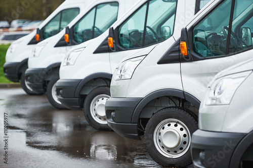 Fotografie, Obraz transporting service company. commercial delivery vans in row