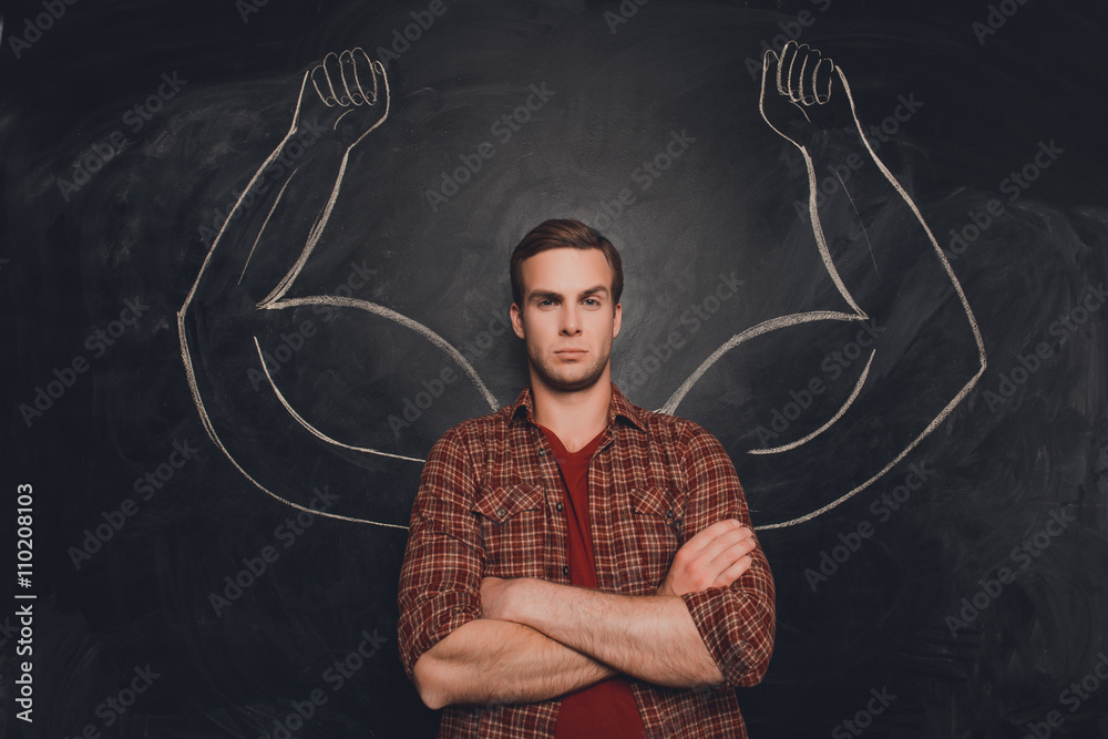 Young handsome man in  shirt with drawn powerful hands
