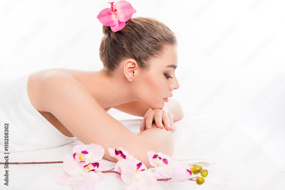 Pretty woman with closed eyes resting in spa, side view photo Pretty woman with closed eyes resting in spa, side view photo