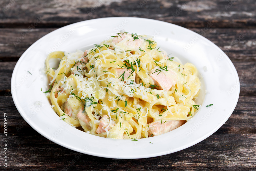 tasty pasta with salmon, dill on plate