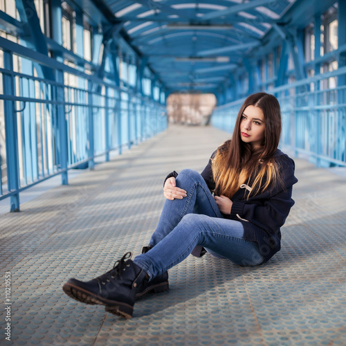 Outdoor fashion lifestyle portrait of pretty young girl, wearing in hipster swag grunge style urban background. Tomboy city concept