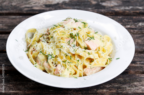 tasty pasta with salmon, dill on plate