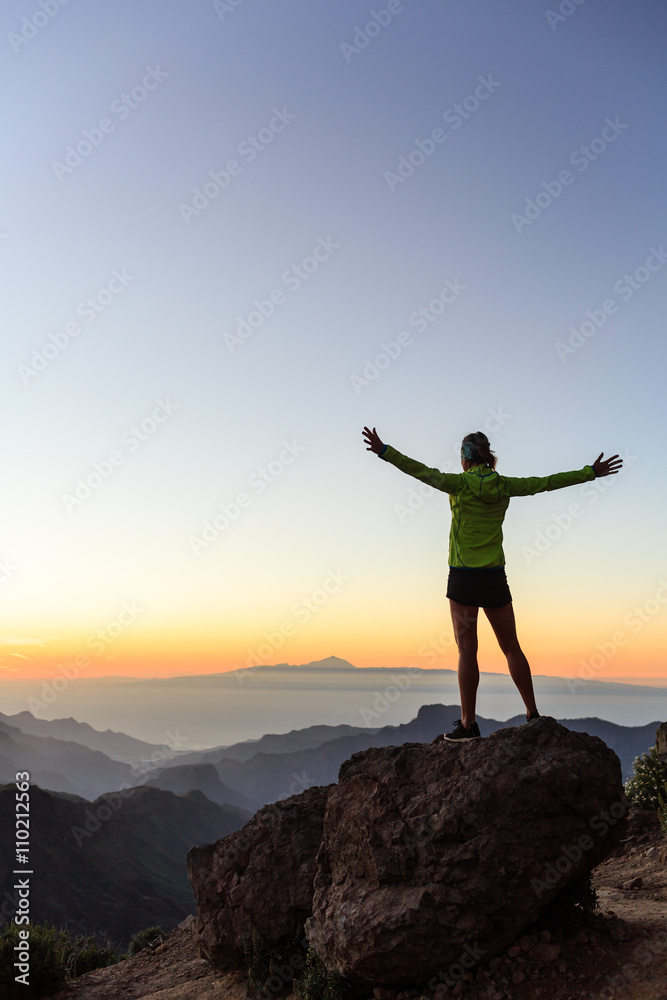 Woman climber success silhouette in inspiring mountains Woman climber success silhouette in inspiring mountains