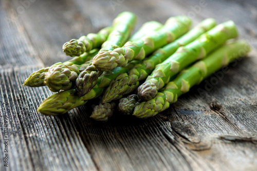  Delicious green asparagus on a wooden background 