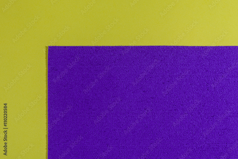 Fototapeta premium Eva foam ethylene vinyl acetate sponge plush purple surface on lemon yellow smooth background