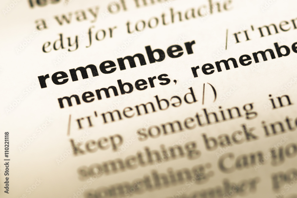 Fototapeta premium Close up of old English dictionary page with word remember