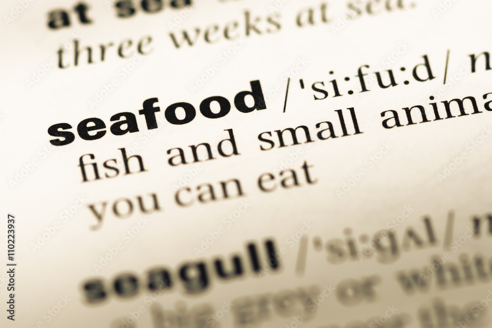 Close up of old English dictionary page with word seafood Close up of old English dictionary page with word seafood