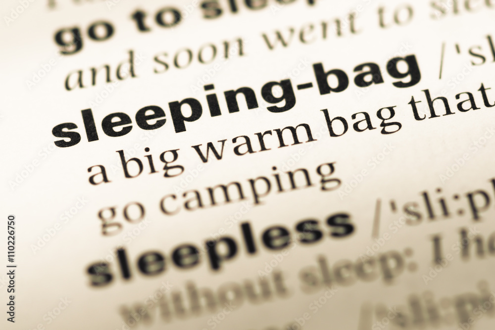 Close up of old English dictionary page with word sleeping bag Close up of old English dictionary page with word sleeping bag