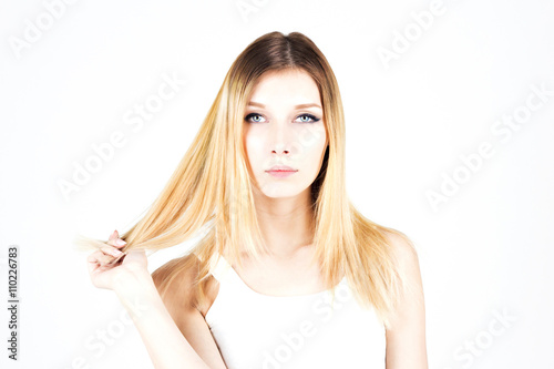 Beautiful blonde woman with dyed hair. Modern haircut.