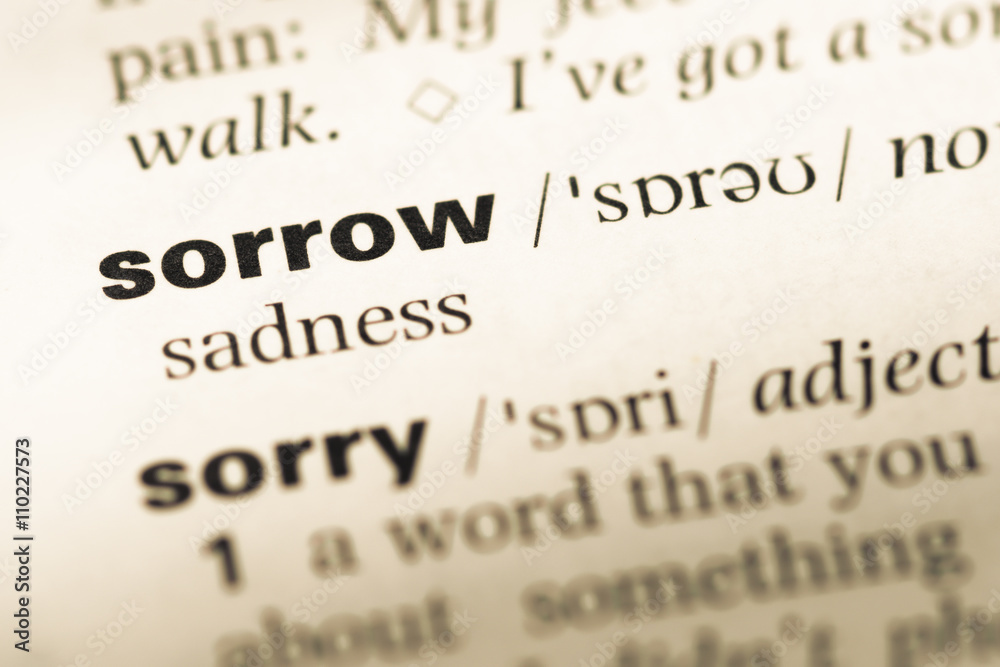 Close up of old English dictionary page with word sorrow Close up of old English dictionary page with word sorrow