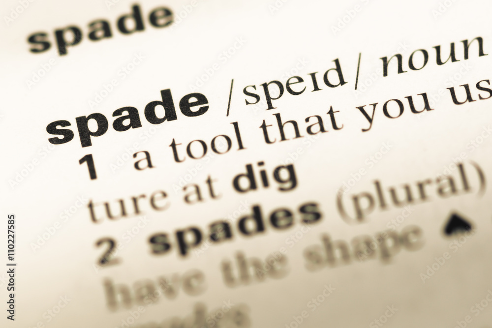 Close up of old English dictionary page with word spade Close up of old English dictionary page with word spade