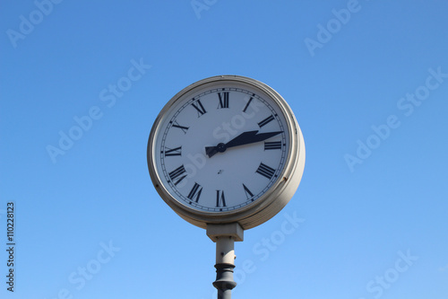  station clock on blue sky background