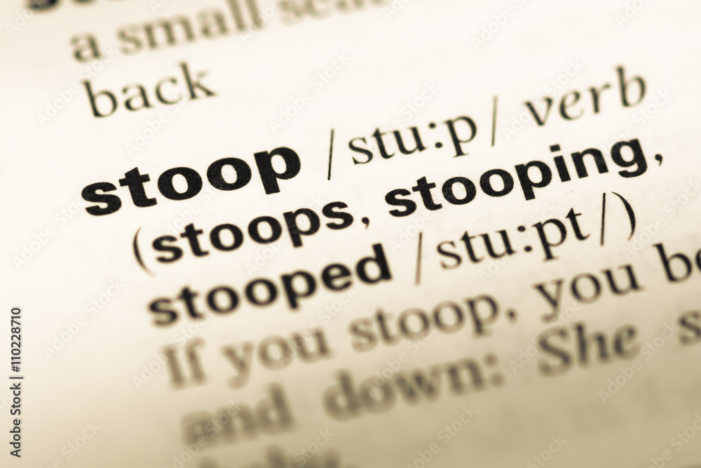Close up of old English dictionary page with word stoop Close up of old English dictionary page with word stoop