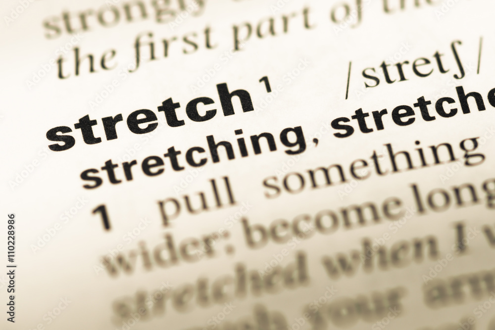Close up of old English dictionary page with word stretch Close up of old English dictionary page with word stretch
