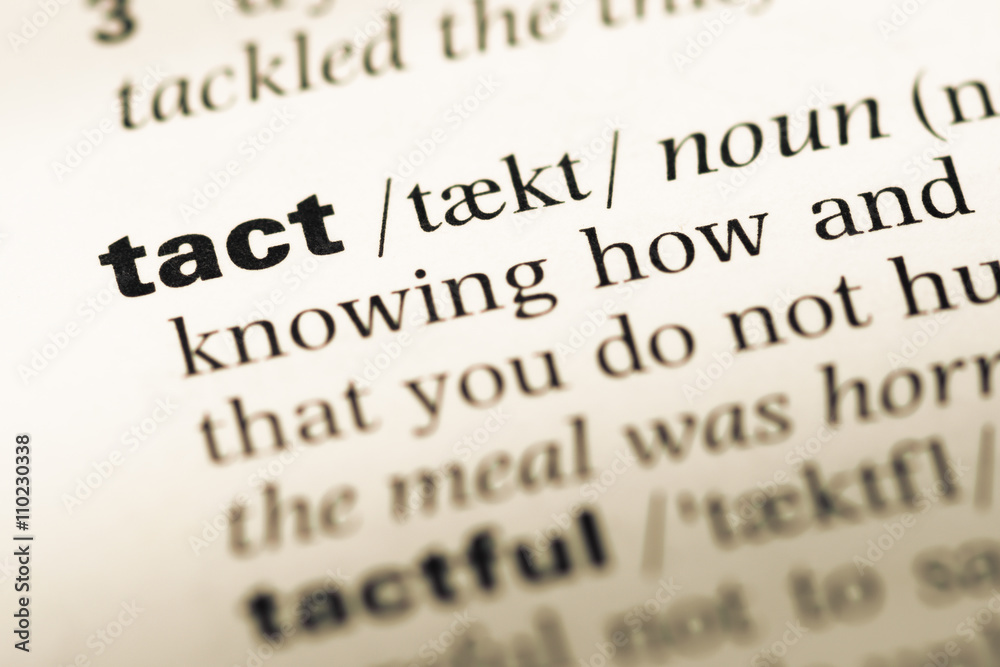 Close up of old English dictionary page with word tact Close up of old English dictionary page with word tact