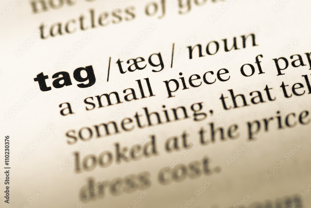 Close up of old English dictionary page with word tag Close up of old English dictionary page with word tag