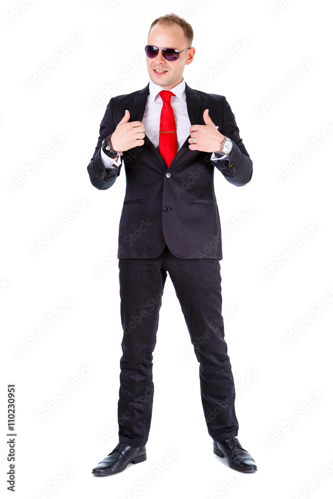 Full length of Elegant business man in black suit, red tie and black glasses, isolated on white background, leather bracelet on man's wrist Full length of Elegant business man in black suit, red tie and black glasses, isolated on white background, leather bracelet on man's wrist