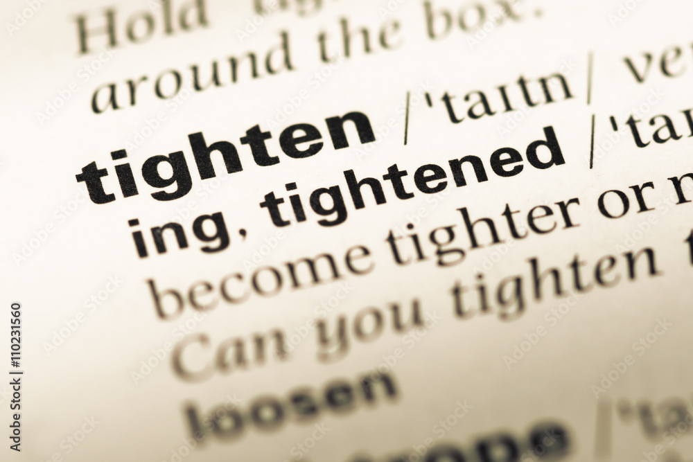 Obraz premium Close up of old English dictionary page with word tighten