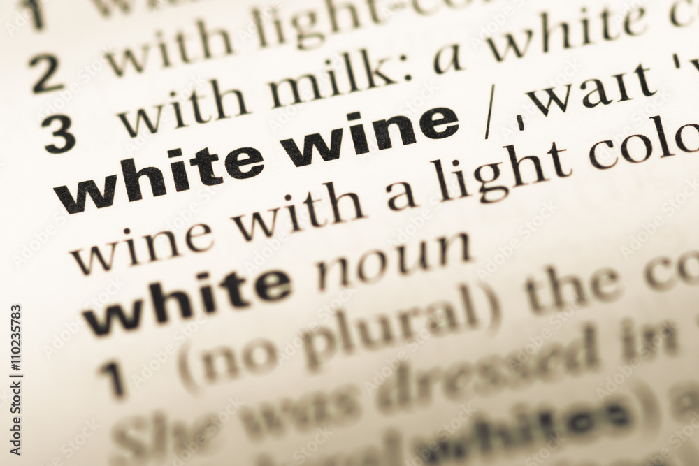 Close up of old English dictionary page with word white wine Close up of old English dictionary page with word white wine