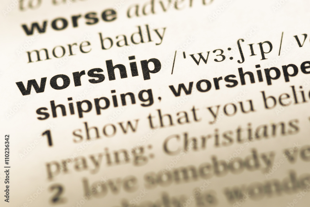 Close up of old English dictionary page with word worship Close up of old English dictionary page with word worship