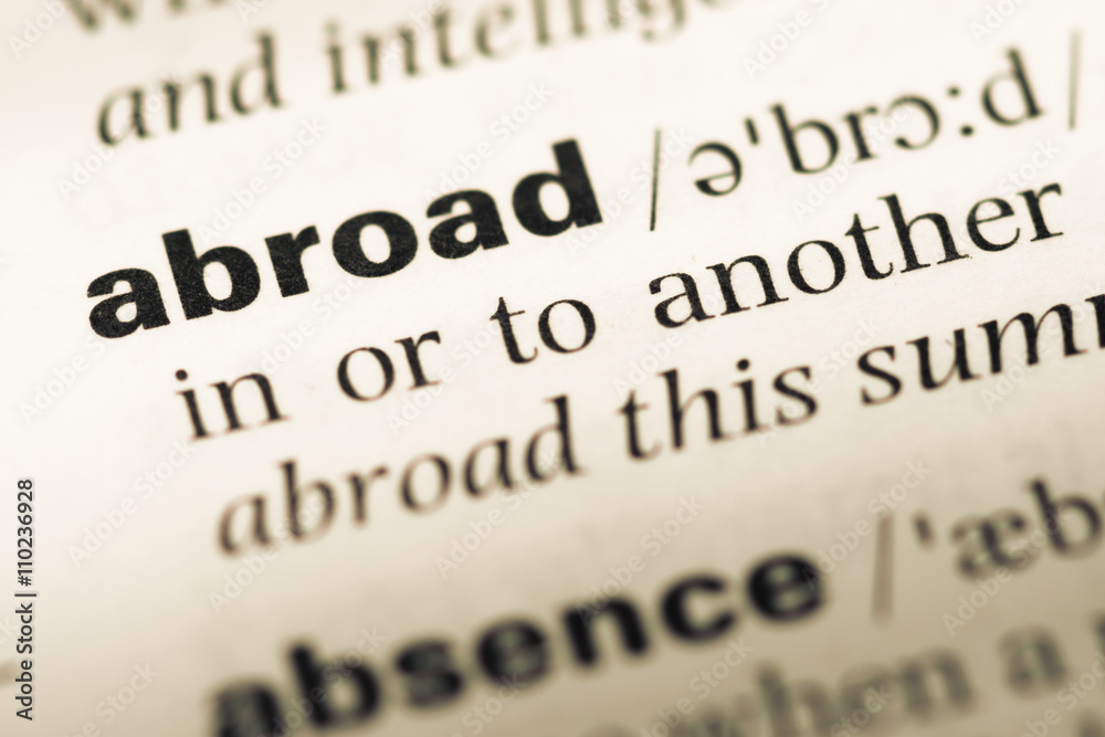 Close up of old English dictionary page with word abroad Close up of old English dictionary page with word abroad