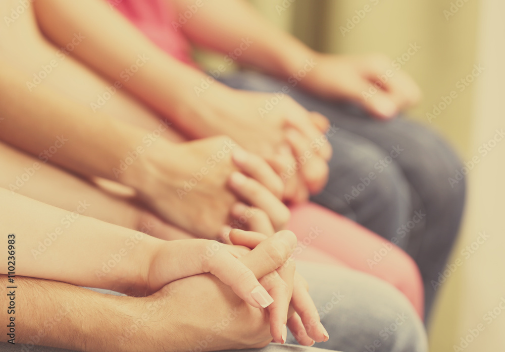 Young people holding hands close up Young people holding hands close up