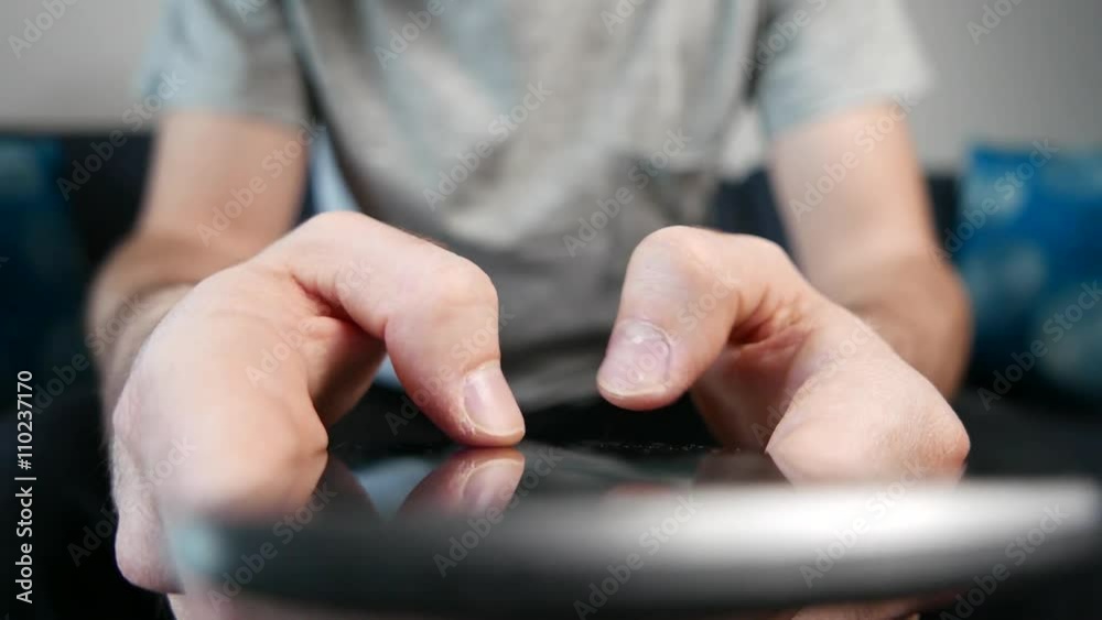 Dramatic closeup shot of a man texting on his smartphone. Dramatic closeup shot of a man texting on his smartphone.