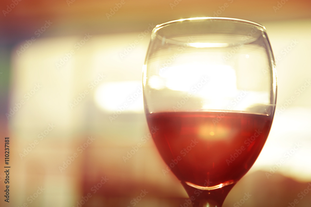 Glass of red wine on blurred background Glass of red wine on blurred background